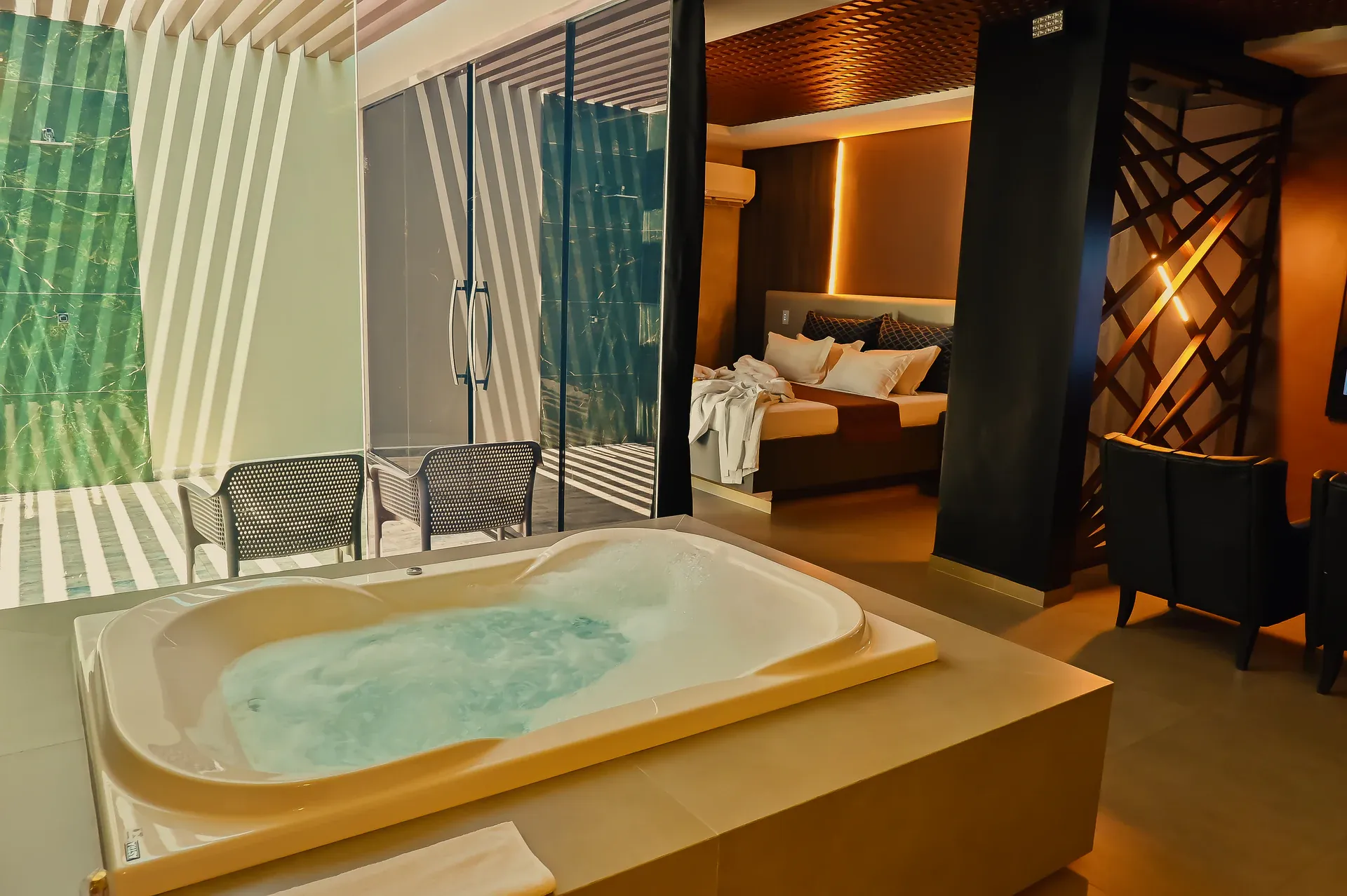 Hidromassagem, piscina externa e cama integradas na Suíte Opium